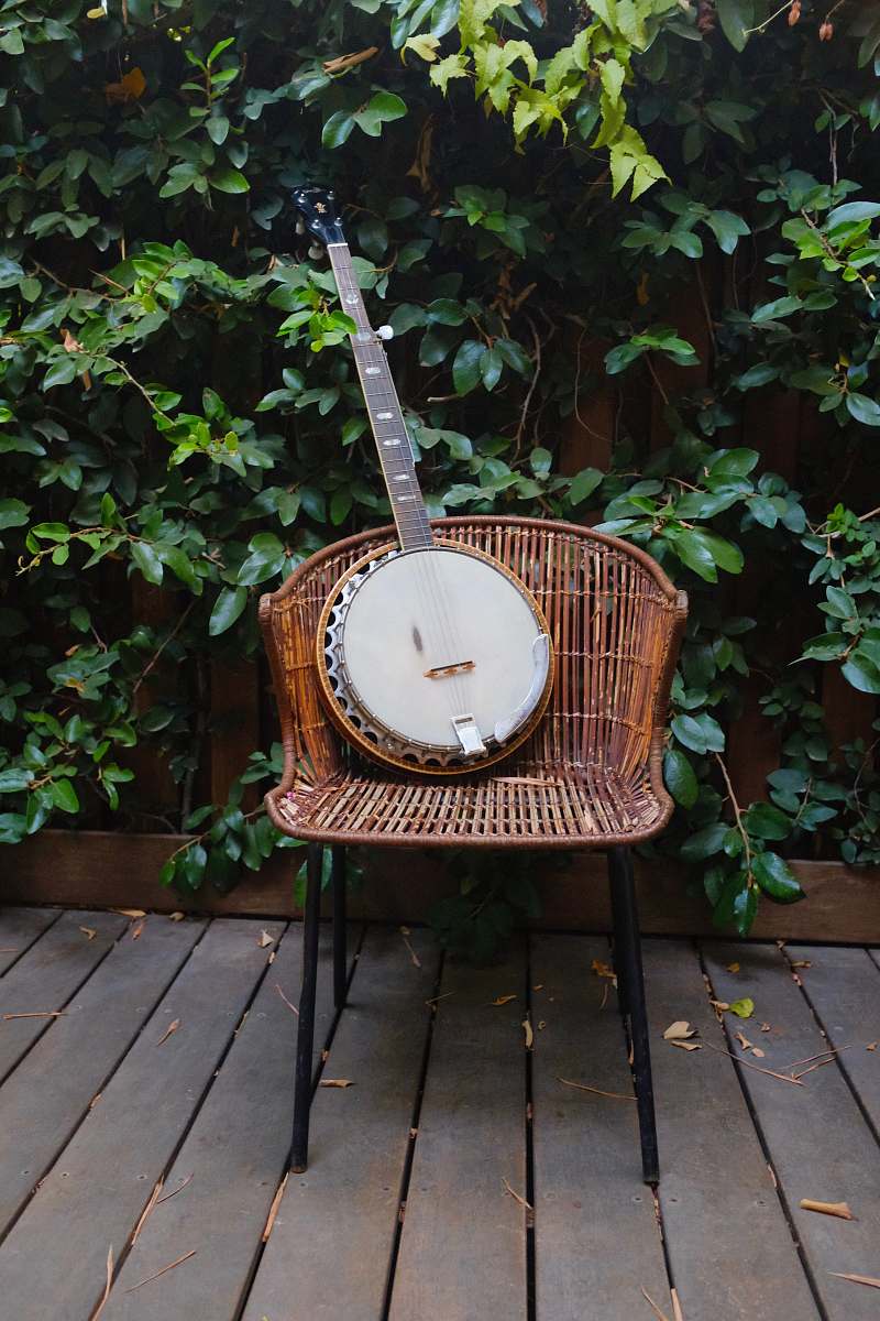 architecture shallow focus photo banjo on brown wicker chair building